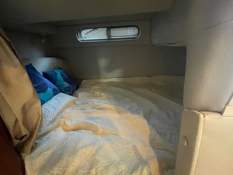 Slide: The Image of Cozy cabin interior of 2004 Chaparral Signature 290 with bed and decorative pillows. - 16