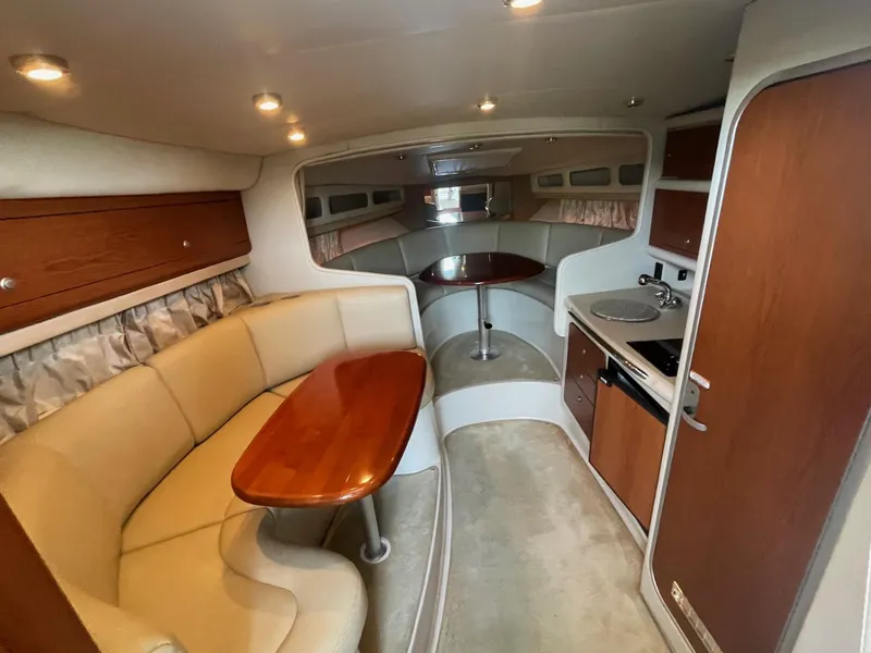 Slide: The Image of 2004 Chaparral Signature 290 interior with cozy seating, kitchenette, and dining area. - 17