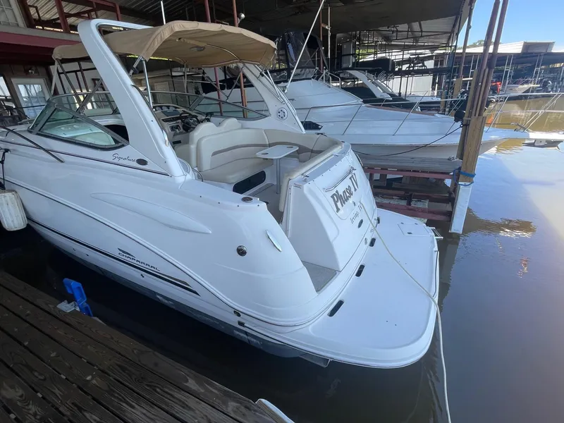 Slide: The Image of 2004 Chaparral Signature 290 boat docked in a marina, rear view. - 3