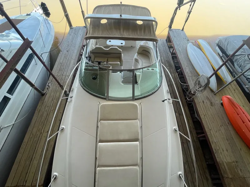 Slide: The Image of 2004 Chaparral Signature 290 boat docked, top view, with surrounding wooden platforms. - 5