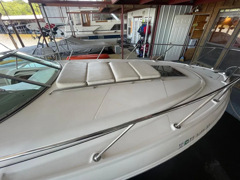 Slide: The Image of 2004 Chaparral Signature 290 boat docked, featuring a spacious deck and sleek design. - 8