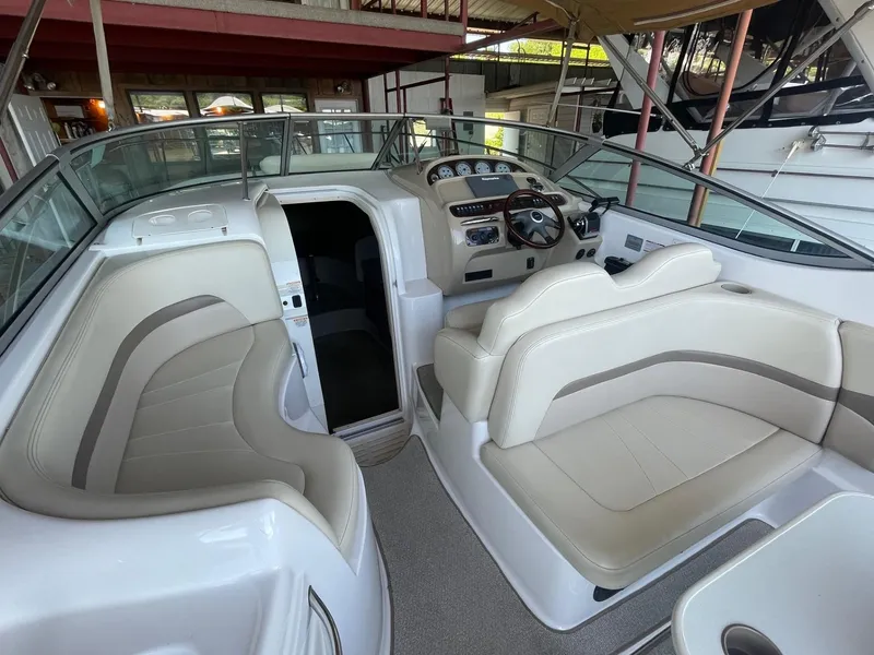 Slide: The Image of 2004 Chaparral Signature 290 boat interior with beige seating and control panel. - 9
