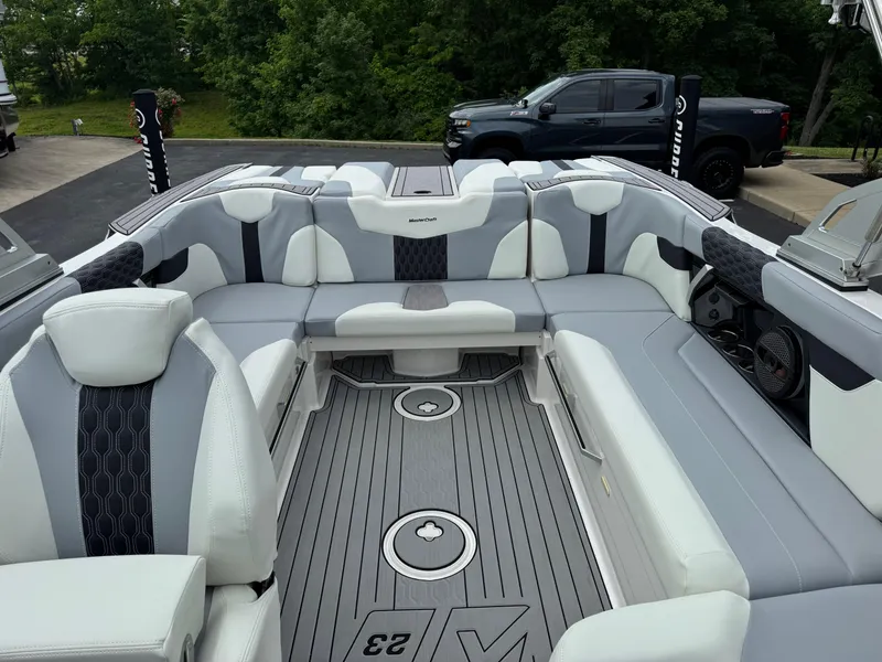 Slide: The Image of 2023 MasterCraft XT23 boat interior with luxurious seating and modern design. - 11