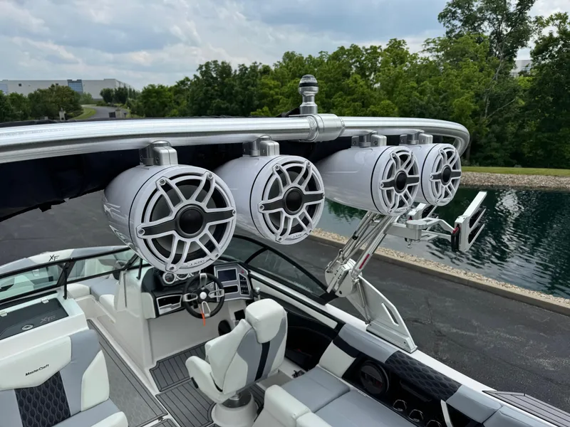 Slide: The Image of 2023 MasterCraft XT23 boat with premium audio system and sleek interior design. - 12