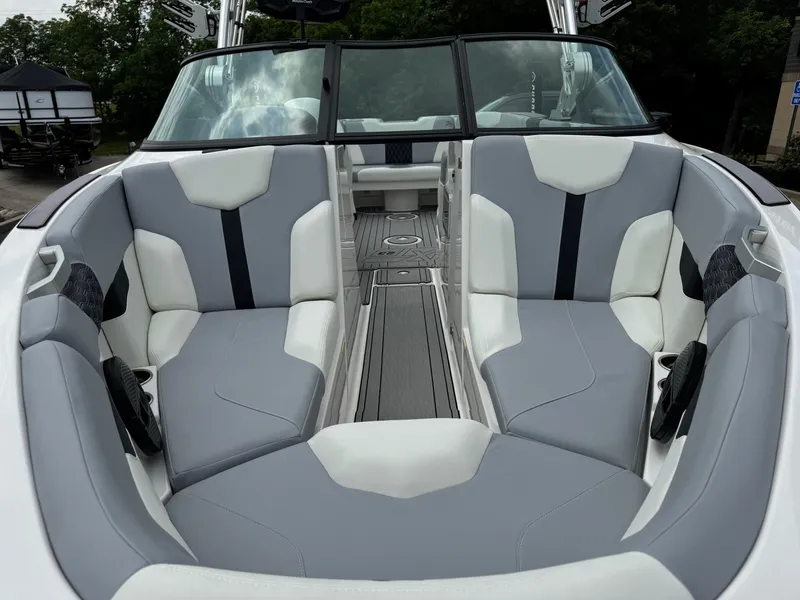 Slide: The Image of 2023 MasterCraft XT23 boat interior with gray and white seating, sleek design. - 7