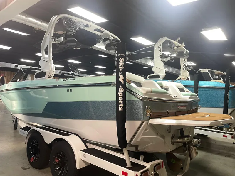 The Image of 2025 Nautique Super Air Nautique GS20 boat in showroom, rear view on trailer. - 1