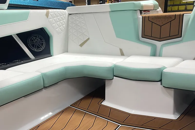 Slide: The Image of 2025 Nautique Super Air Nautique GS20 interior with mint and white seating, wood accents. - 4