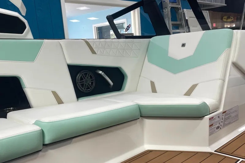Slide: The Image of 2025 Nautique Super Air Nautique GS20 interior seating with teal and white upholstery. - 5