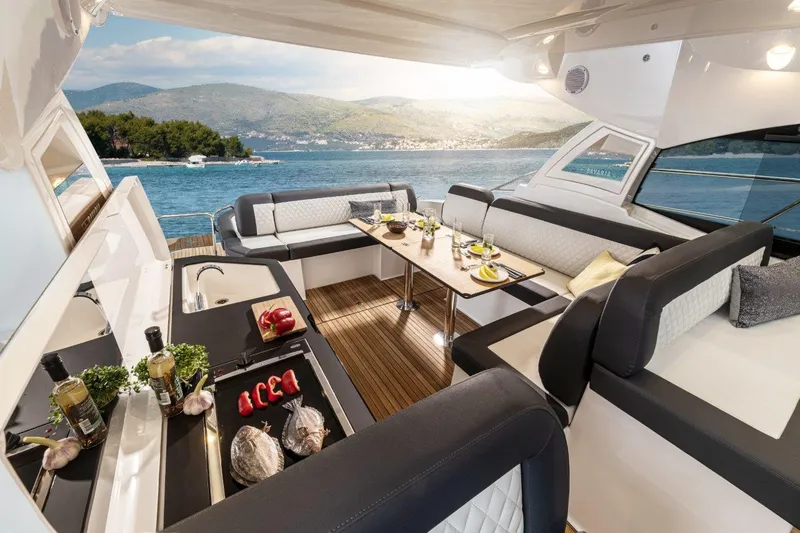 Slide: The Image of Luxurious 2023 Bavaria SR41 COUPE yacht interior with elegant seating and dining area. - 10