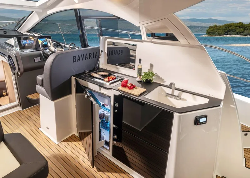 Slide: The Image of 2023 Bavaria SR41 COUPE yacht interior with kitchenette and ocean view. - 11
