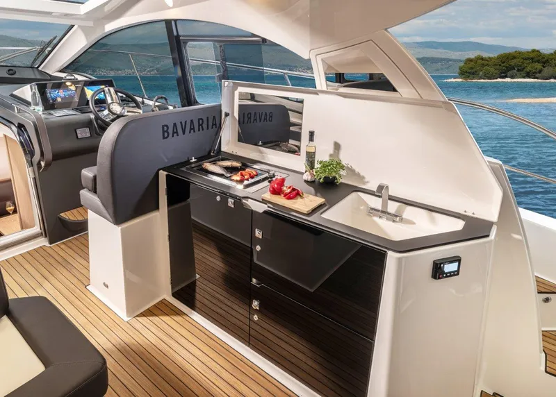 Slide: The Image of 2023 Bavaria SR41 COUPE yacht interior with modern kitchen and ocean view. - 12