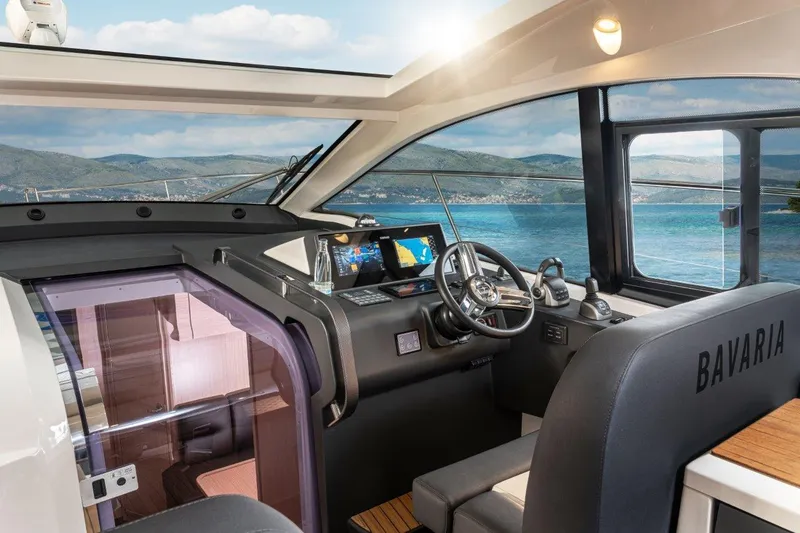 Slide: The Image of Interior of 2023 Bavaria SR41 COUPE yacht with modern helm and scenic ocean view. - 16