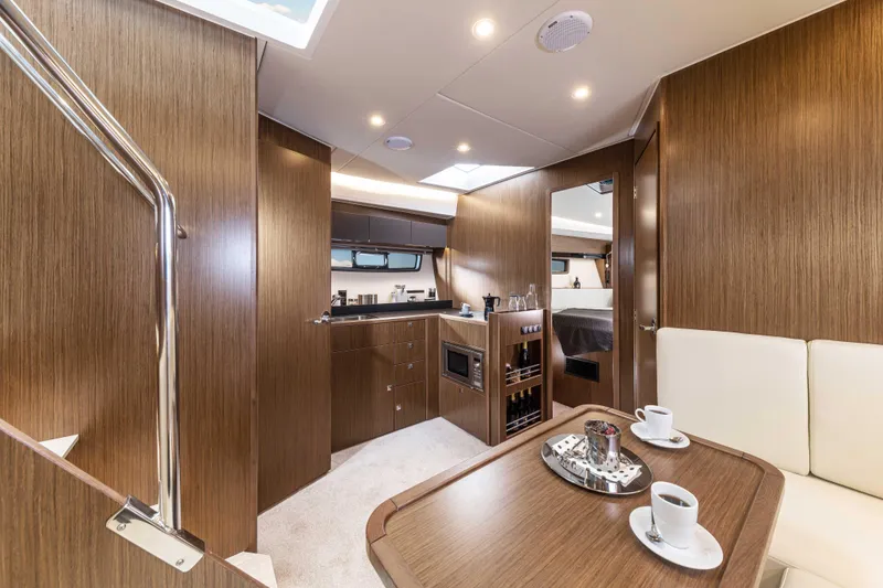 Slide: The Image of Luxurious interior of 2023 Bavaria SR41 COUPE yacht with modern kitchen and dining area. - 5