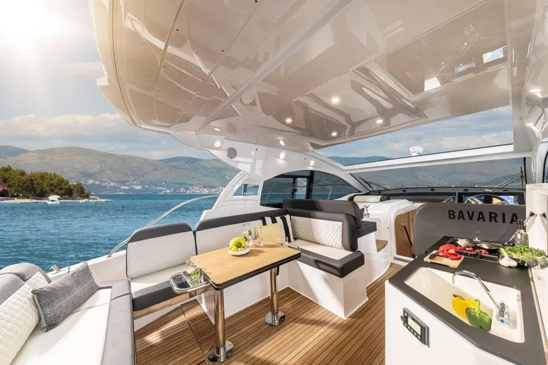 Slide: The Image of Luxurious 2023 Bavaria SR41 COUPE yacht interior with elegant seating and dining area. - 9