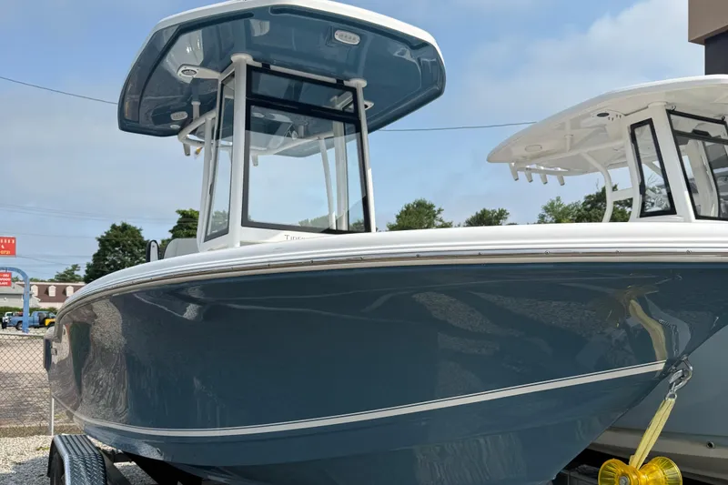 The Image of 2026 Tidewater 210CC boat on trailer, blue hull, outdoor display. - 0