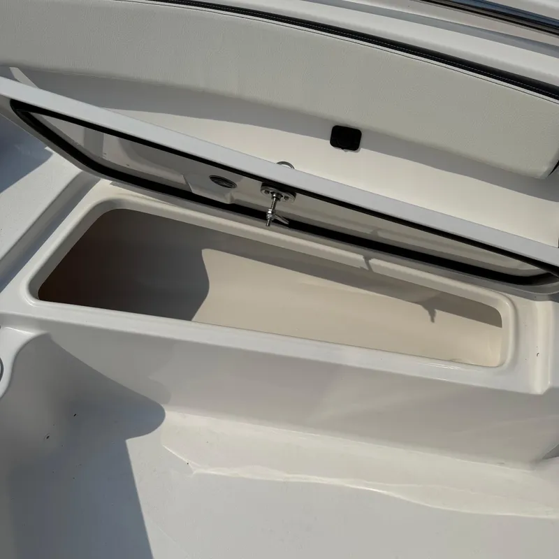Slide: The Image of Open storage compartment on 2026 Tidewater 210CC boat. - 12