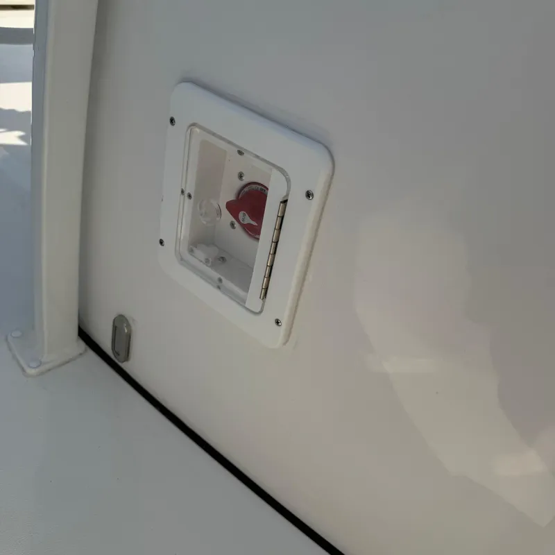 Slide: The Image of Battery switch on 2026 Tidewater 210CC boat, white panel detail. - 13