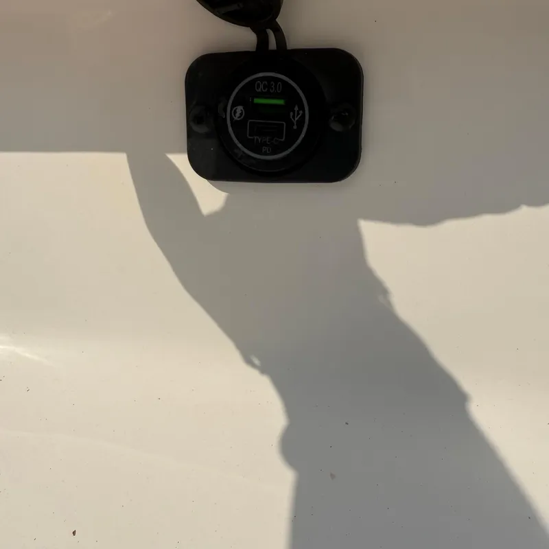 Slide: The Image of USB charging port on 2026 Tidewater 210CC boat, featuring QC 3.0 technology. - 14