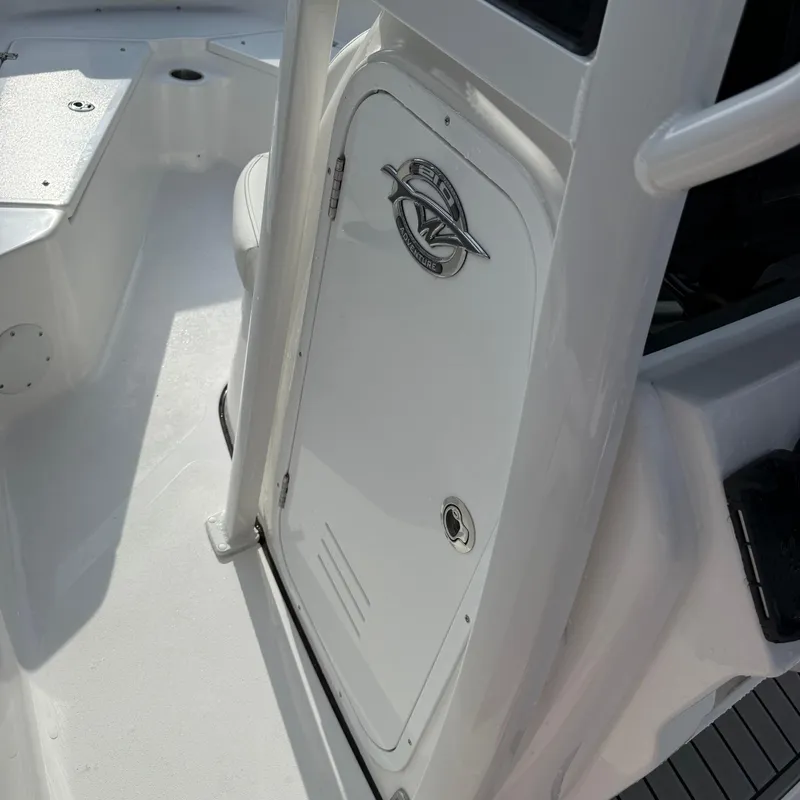 Slide: The Image of 2026 Tidewater 210CC boat interior with storage compartment and sleek white finish. - 21