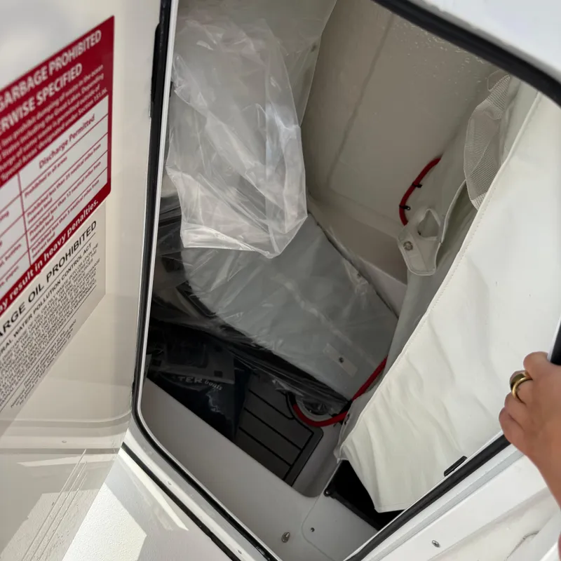 Slide: The Image of Interior view of a 2026 Tidewater 210CC boat storage compartment. - 22