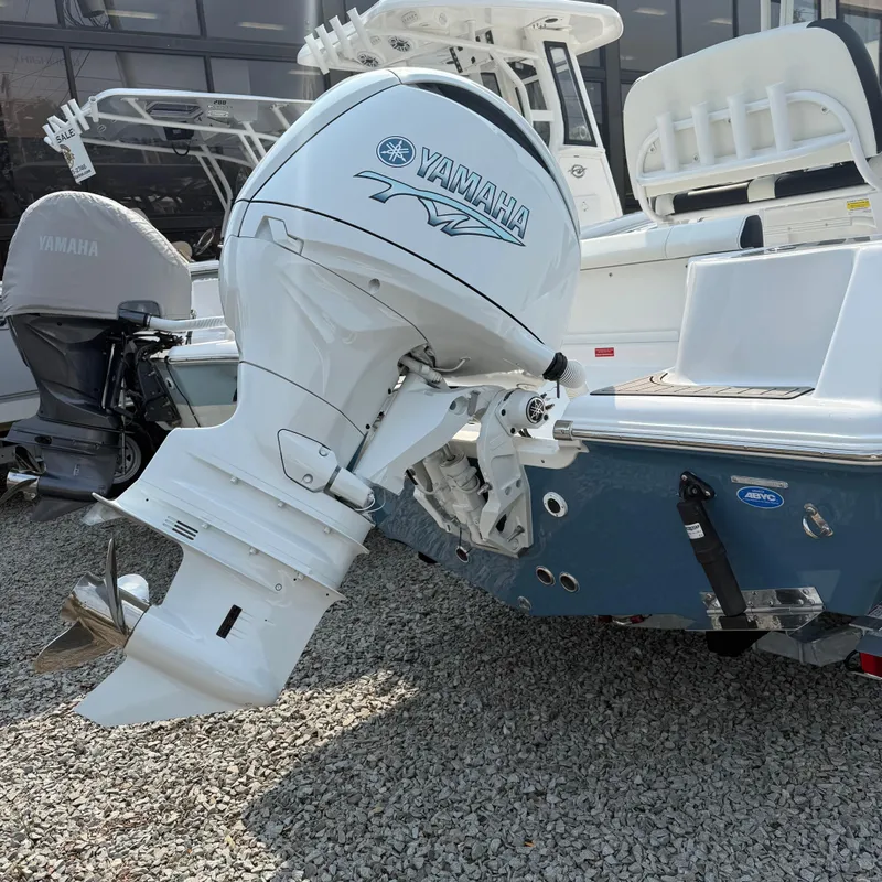 Slide: The Image of 2026 Tidewater 210CC boat with Yamaha outboard motor on gravel surface. - 3