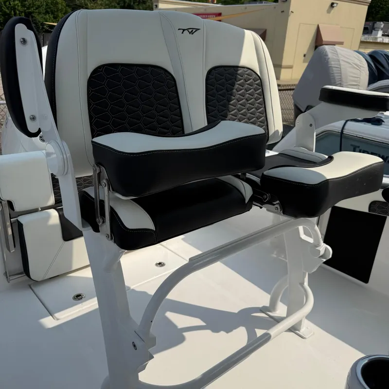 Slide: The Image of 2026 Tidewater 210CC boat seat with black and white cushioned design. - 5