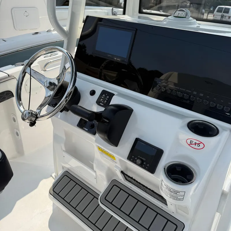 Slide: The Image of 2026 Tidewater 210CC boat dashboard with steering wheel and control panel. - 6