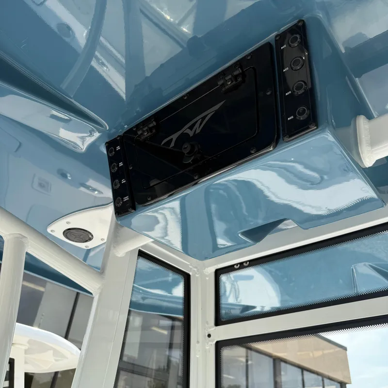 Slide: The Image of Interior view of 2026 Tidewater 210CC boat, featuring sleek blue design and control panel. - 7
