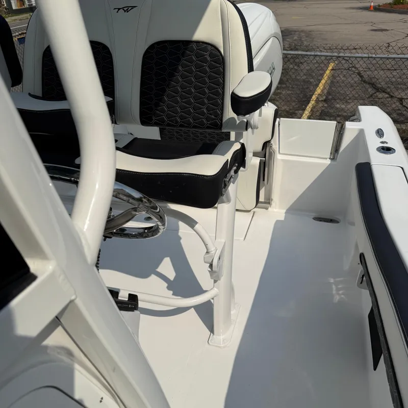 Slide: The Image of 2026 Tidewater 210CC boat interior with sleek seating and steering wheel. - 9