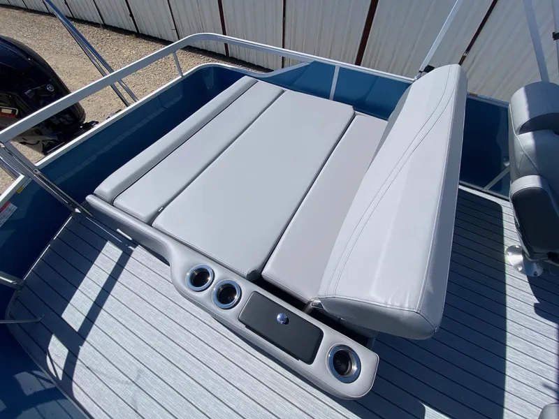 Slide: The Image of SunCatcher Fusion 324SL 2025 boat with gray seating and cup holders on deck. - 14
