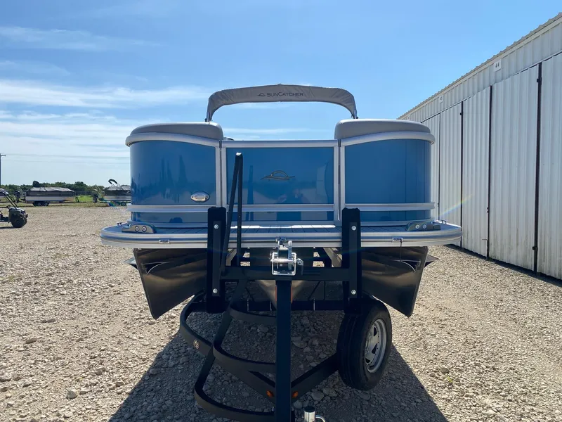 Slide: The Image of 2025 SunCatcher Fusion 324SL pontoon boat on trailer, parked outdoors. - 3