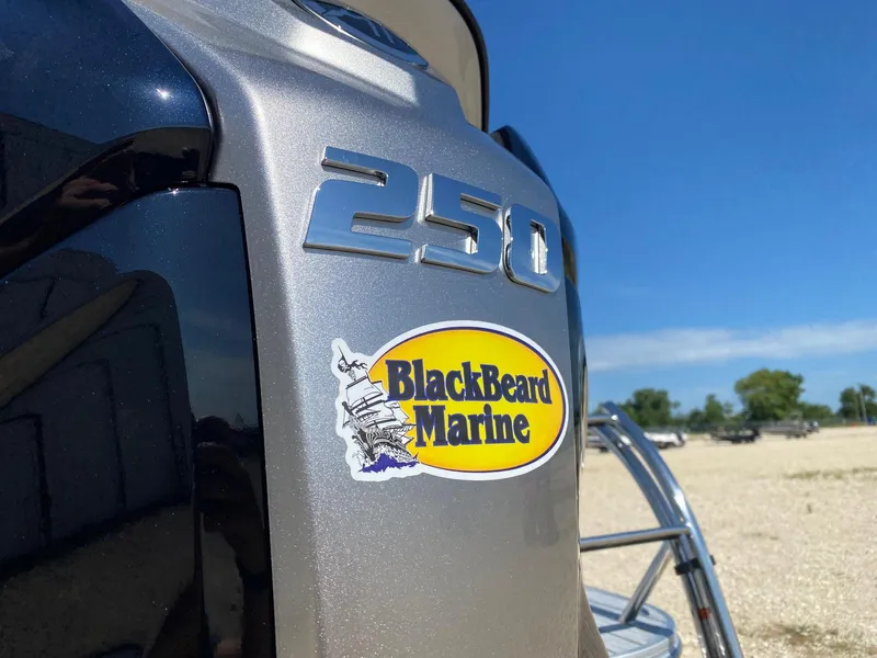 Slide: The Image of 2025 SunCatcher Fusion 324SL boat with BlackBeard Marine sticker, sunny outdoor setting. - 6