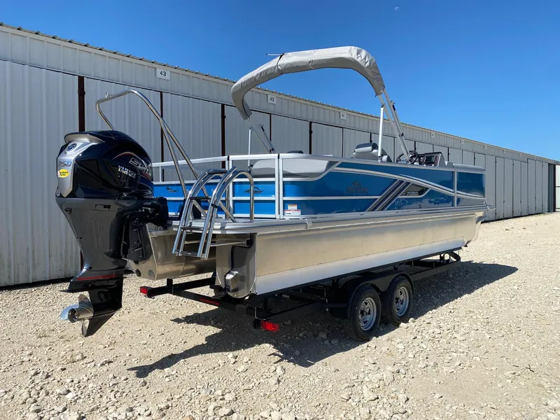 Slide: The Image of 2025 SunCatcher Fusion 324SL pontoon boat with Yamaha outboard motor, parked on a trailer. - 7