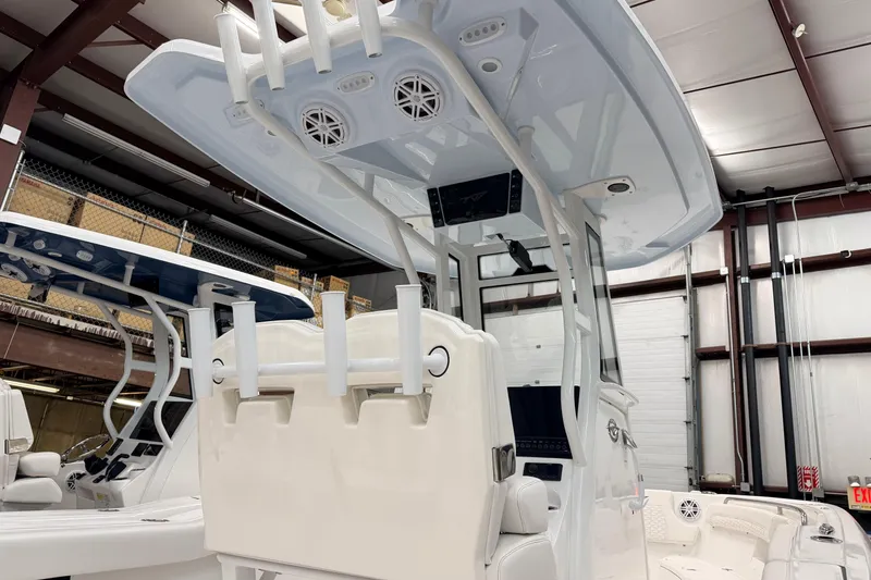 Slide: The Image of 2026 Tidewater 232 LXF boat in showroom. - 7