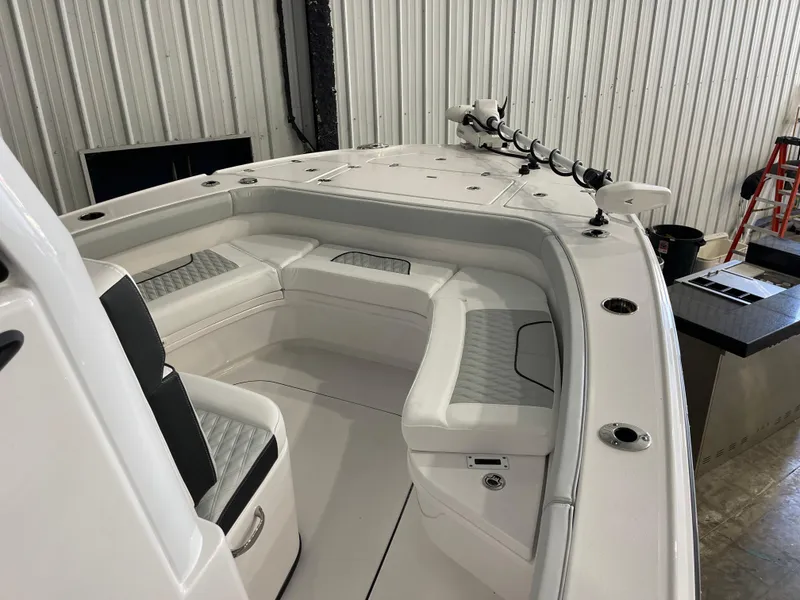 Slide: The Image of 2026 Blackfin 262 HB boat interior with cushioned seating and fishing rod holders. - 20