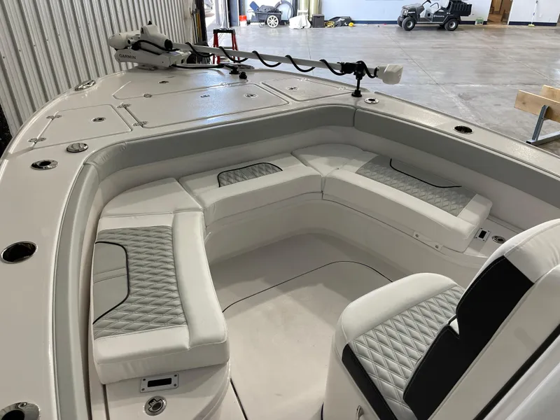 Slide: The Image of 2026 Blackfin 262 HB boat interior with cushioned seating and Garmin equipment. - 22