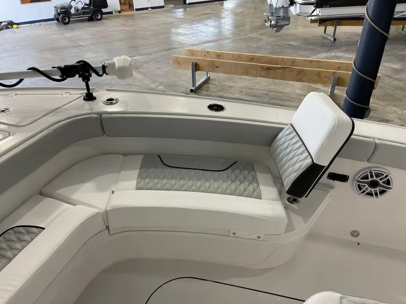 Slide: The Image of 2026 Blackfin 262 HB boat interior with cushioned seating and speaker. - 25