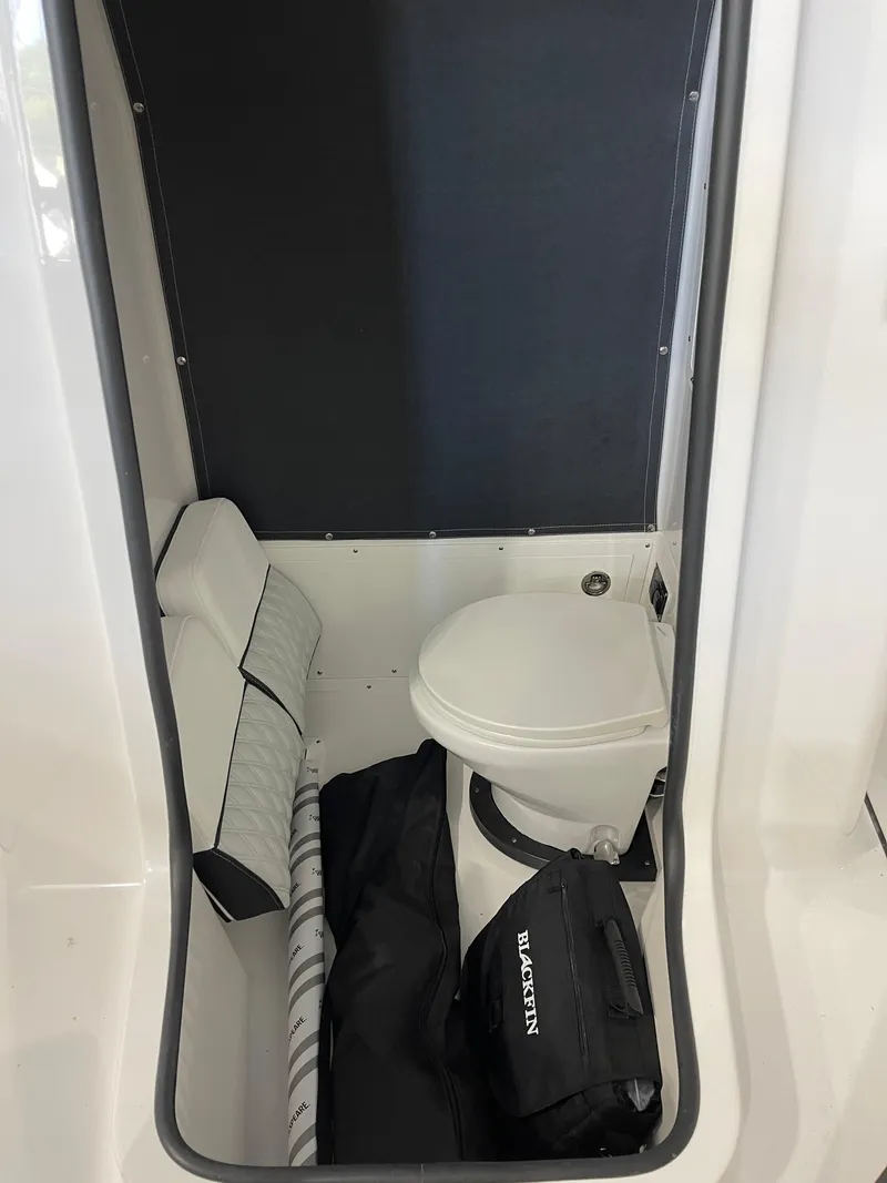 Slide: The Image of Interior of 2026 Blackfin 262 HB boat, featuring compact marine toilet and storage. - 27