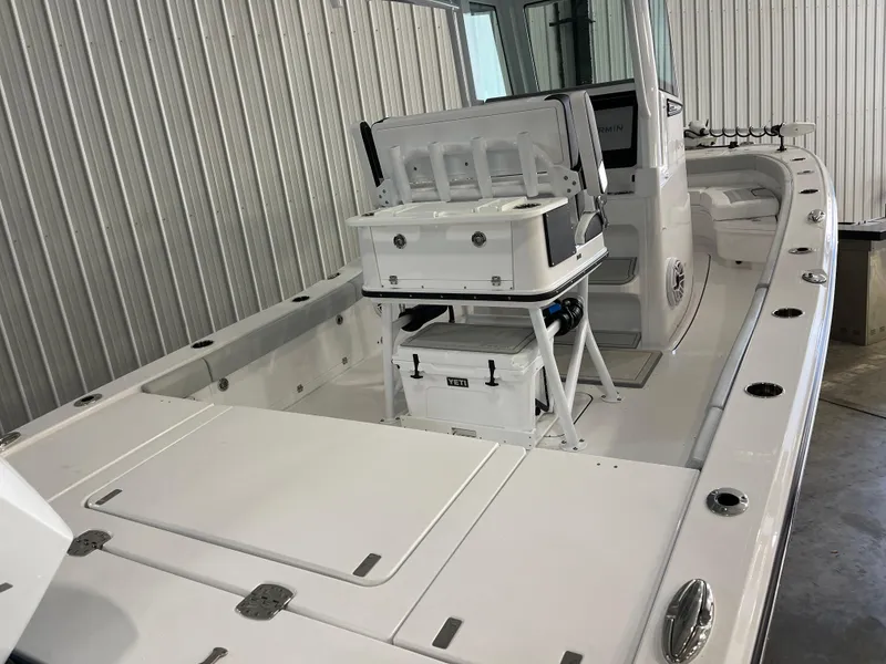 Slide: The Image of 2026 Blackfin 262 HB boat interior with seating and storage in a metal-walled showroom. - 8