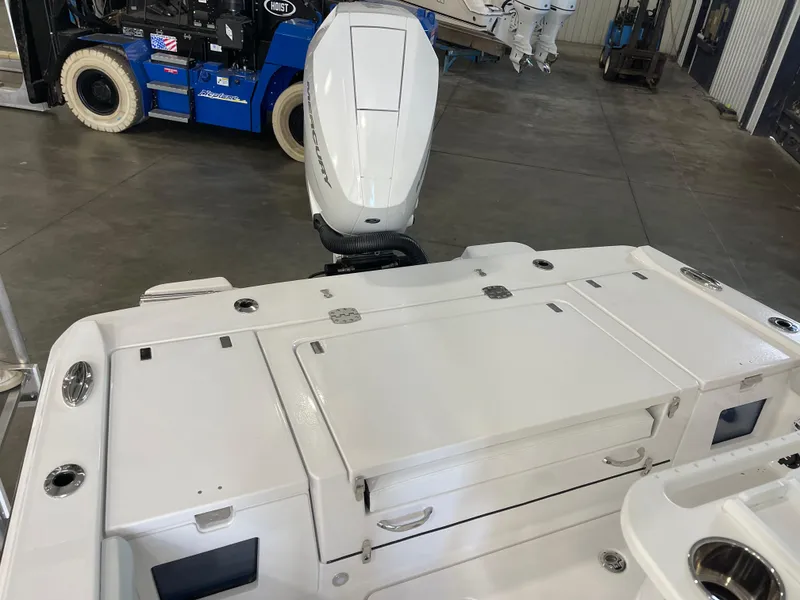 Slide: The Image of 2026 Blackfin 262 HB boat with Mercury engine in a warehouse setting. - 9
