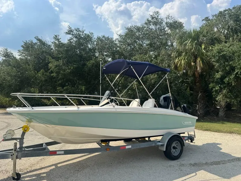 Slide: The Image of 2016 Boston Whaler 170 Super Sport boat on trailer, parked outdoors. - 11