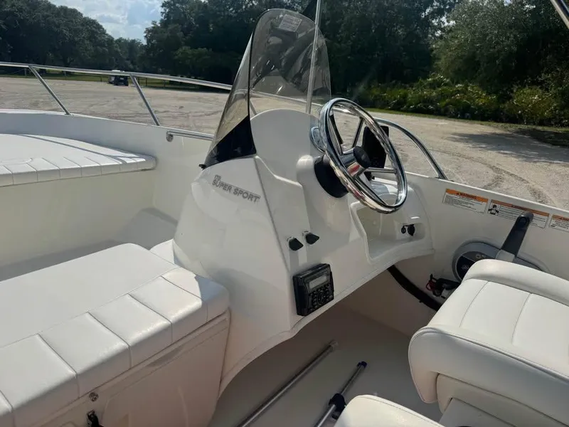 Slide: The Image of 2016 Boston Whaler 170 Super Sport interior with steering wheel and seating. - 13