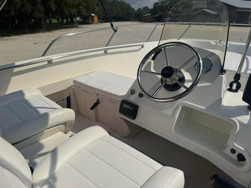 Slide: The Image of 2016 Boston Whaler 170 Super Sport boat interior with steering wheel and seating. - 14