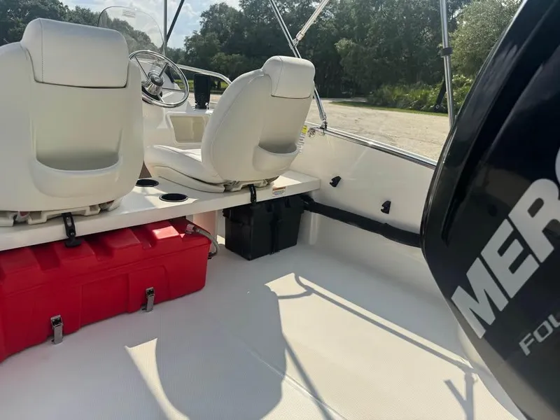 Slide: The Image of 2016 Boston Whaler 170 Super Sport interior with white seats and red storage box. - 15