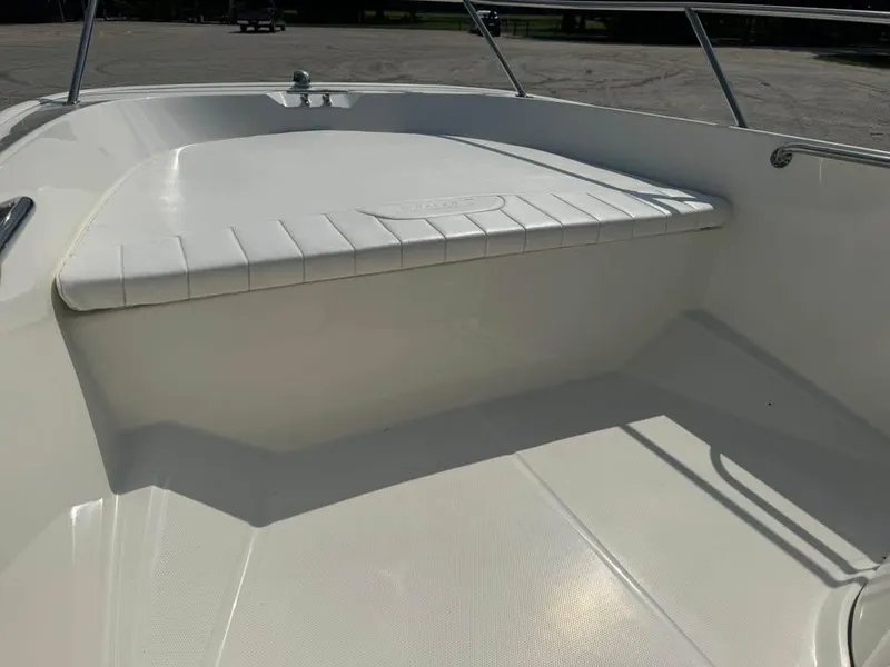 Slide: The Image of 2016 Boston Whaler 170 Super Sport boat interior, featuring a clean, white seating area. - 16