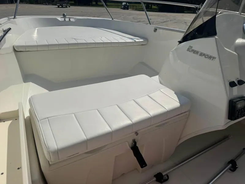 Slide: The Image of 2016 Boston Whaler 170 Super Sport interior with white seating and console. - 17