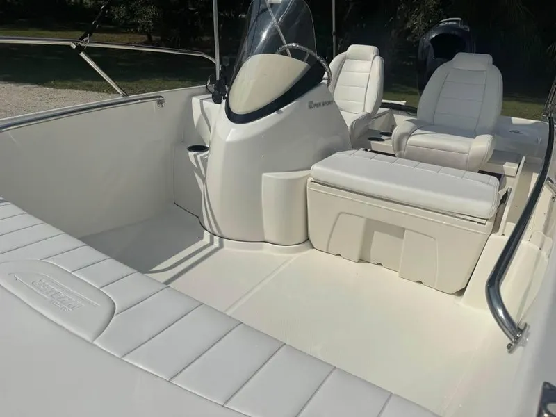 Slide: The Image of 2016 Boston Whaler 170 Super Sport interior with white seating and console. - 18