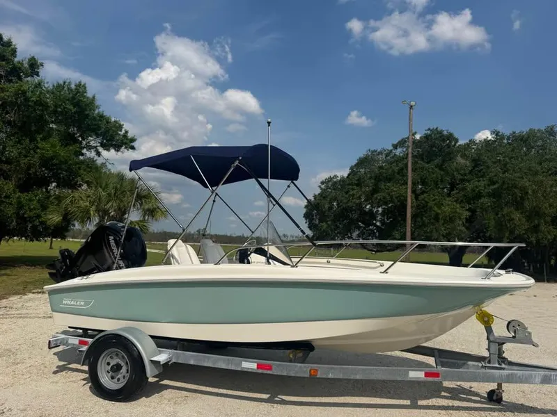 Slide: The Image of 2016 Boston Whaler 170 Super Sport boat on trailer, parked outdoors under blue sky. - 3