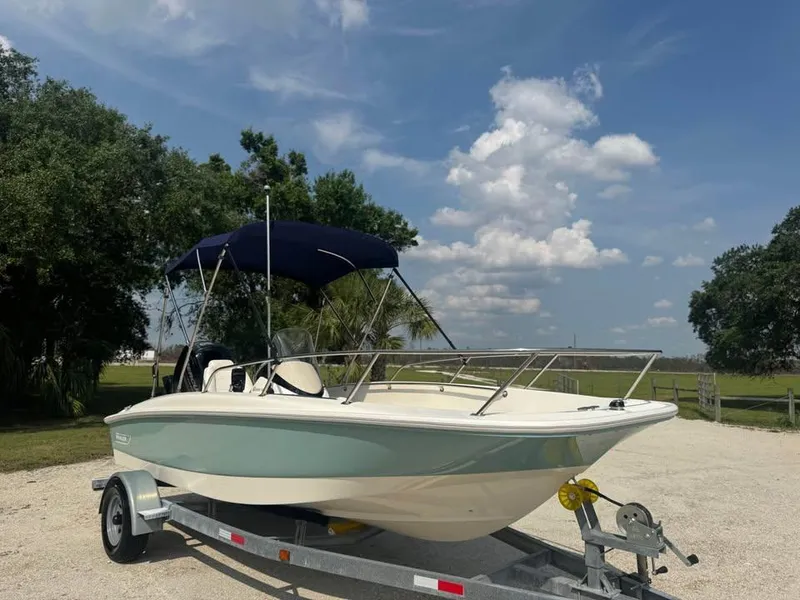 Slide: The Image of 2016 Boston Whaler 170 Super Sport boat on trailer under blue sky. - 5