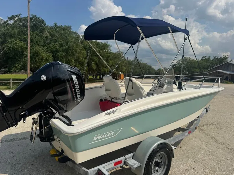 Slide: The Image of 2016 Boston Whaler 170 Super Sport boat with Mercury engine on trailer. - 6